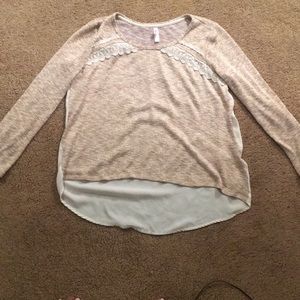 A beige sweater with gold flecks